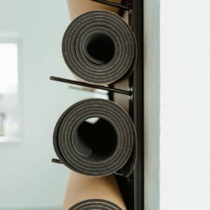 An artistic view of stacked yoga mats in a modern minimalist indoor space.